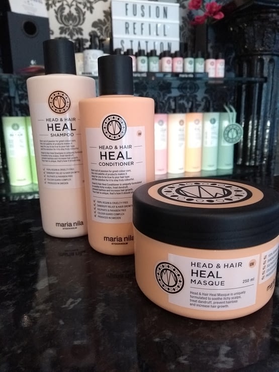 heal your hair and scalp. The image show the 3 products contained in the bundle. Peach in colour with black lids