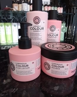 Luminous Colour by Maria Nila. The image shows the four products included in the bundle. Pink in colour with black lids.