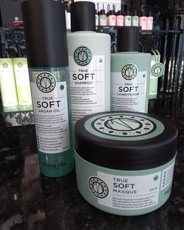 True Soft by Maria Nila. The image shows four hair products in the bundle. Green in colour with black lids.