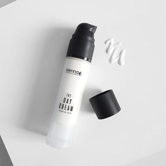 multi-purpose day cream by sienna x. The image shows the product bottle laid down with the black lid removed showing the pump action applicator.