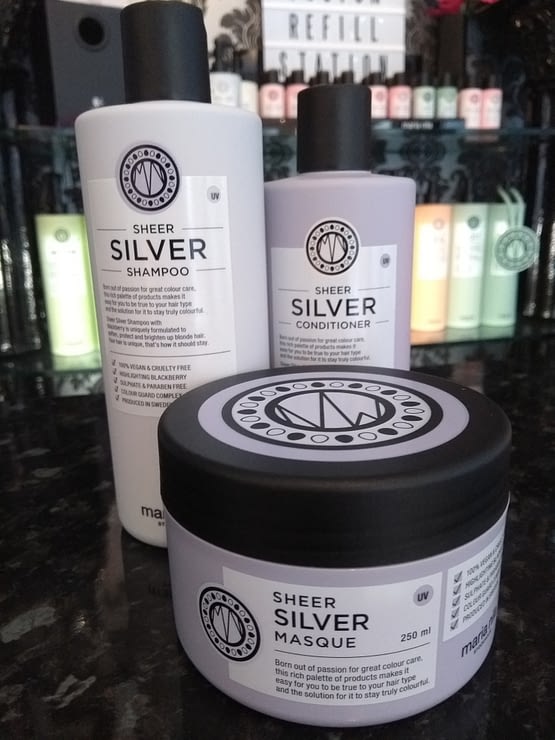 Sheer Silver by maria nila. Saver Bundle. The image shows the shampoo and conditioner bottle in pale grey with black lids and a jar of masque in front in pale grey with a black lid